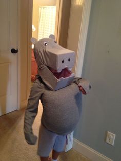 a person in a costume that looks like a hippopotamus holding a laptop