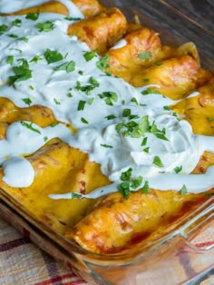 an enchilada dish with sour cream and cilantro