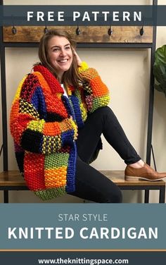 a woman sitting on top of a wooden bench wearing a colorful knitted cardigan