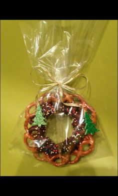 a plastic bag filled with pretzels and christmas decorations