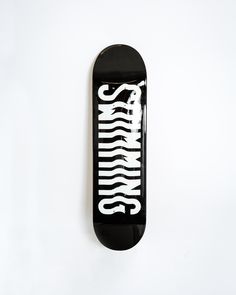 a black skateboard with white writing on the front and bottom part that says, no limits