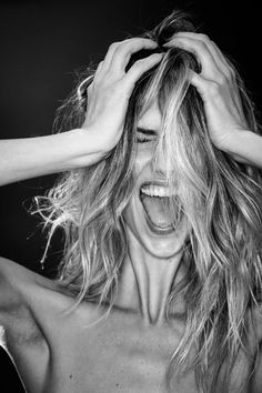 a black and white photo of a woman covering her face