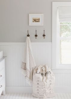 a white bed sitting next to a window in a bedroom