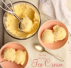 two bowls filled with ice cream on top of a white table next to spoons