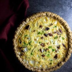 an overhead view of a quiche on a table