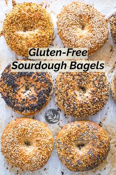 bagels with sesame seeds and poppy seed sprinkles on parchment paper in front of the words gluten - free sourdough bagels