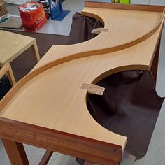 a wooden table with two curved sections on it