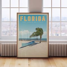 there is a poster with a boat on the beach and a palm tree in front of it