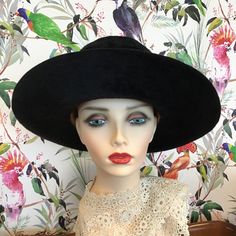 A fabulous vintage 1969 designer hat 'Meteor 15' by artisan hat makers Herbert Johnson of Bond Street London. Made from a black silk plush fabric, it features a wide brim and a high crease. The black band is rib corded and has a flat bow on the left side. The lining is ivory satin and is gathered at the crown. The crown is protected with a clear plastic cover, under which the maker's name is printed in gold and black, and there is also the royal coat of arms, by Appointment to Her Majesty The Qu Black Boater Hat With Curved Brim For Church, Black Curved Brim Boater Hat For Church, Black High Crown Hat For Evening, Black Hat With Curved Brim For Royal Ascot, Black Curved Brim Hat For Royal Ascot, Black Curved Brim Costume Hat For Church, Black Curved Brim Hat For Church, Black Costume Hat With Curved Brim For Church, Black Costume Hat For Church With Curved Brim