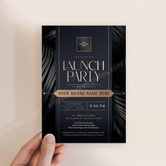 a black and gold party flyer with palm leaves on the front is held up by a person's hand