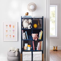 a bookshelf filled with lots of books next to a window