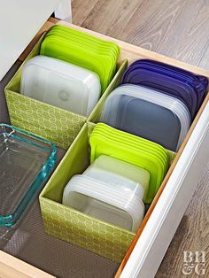 an open drawer filled with assorted plastic containers