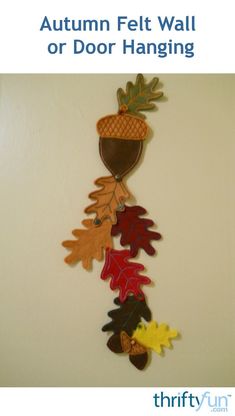 an autumn felt wall or door hanging with leaves and acorns in the fall colors