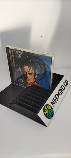 a cd case with an anime cover on the front and back sides, sitting on top of a white surface