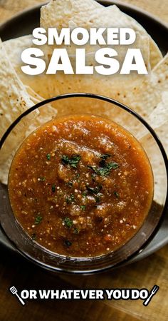 a bowl filled with salsa next to tortilla chips