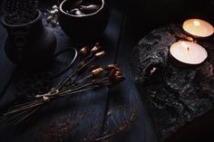 some candles are sitting on top of a rock