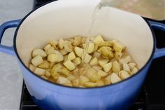 potatoes being cooked in a pot on the stove