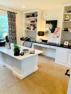 a home office with white desk and black chairs