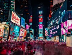 a crowded city street filled with lots of neon signs