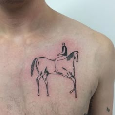 a man with a tattoo on his chest has a horse and rider drawn on it