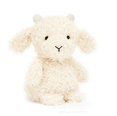 a white stuffed animal sitting up against a white background