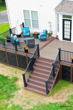 an overhead view of a deck with chairs and umbrellas on the grass next to a house