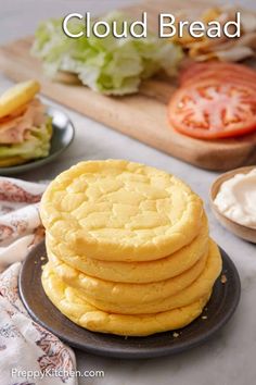 a stack of pancakes sitting on top of a plate next to a pile of lettuce