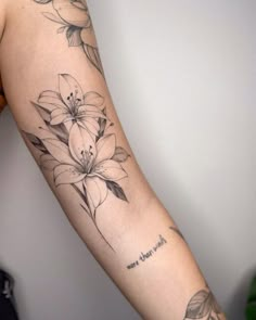 a woman's arm with flowers on it