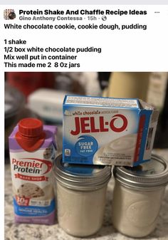 three jars of jello sitting on top of a counter next to milk and yogurt