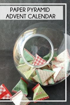 paper pyramids in a glass bowl with the words paper pyramid advent calendar on it