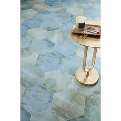 a table with a tray on top of it next to a blue tile flooring