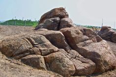 large rocks in the sand on a sunny day