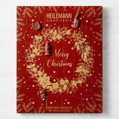 a red christmas card with gold lettering and holly wreath on the front, surrounded by chocolate candies