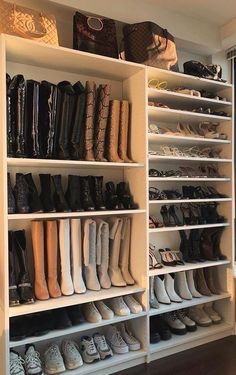 there are many pairs of shoes on the shelves in this closet that is filled with purses