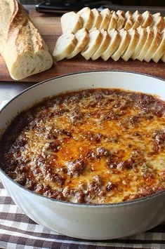 a bowl of chili with bread on the side