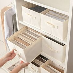 a woman is opening the drawers in her closet