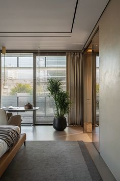 a living room with a couch, chair and table in front of large sliding glass doors