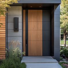 a modern entrance with wooden doors and plants