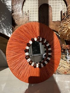 a round mirror sitting on top of a table