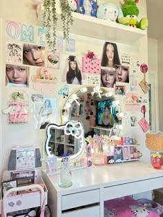 a white desk topped with a mirror and lots of pictures