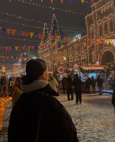 people are walking around an outdoor christmas market