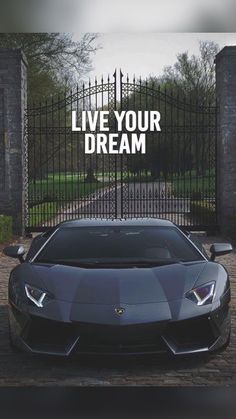 a car parked in front of a gate with the words live your dream on it