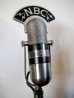 an old fashioned microphone with the word nbg on it's side and black lettering