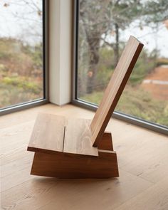 a piece of wood sitting on top of a hard wood floor next to a window