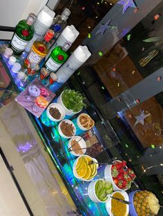 a buffet table filled with lots of food and condiments on top of it