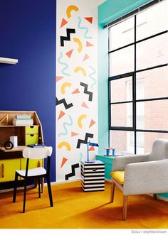 a living room filled with furniture and colorful walls