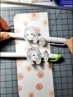 someone is cutting out some stickers on paper with scissors and glue to make them look like they are making faces