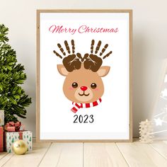 a christmas card with a reindeer's handprint on it