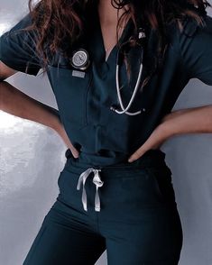 a woman wearing a black scrub suit with a stethoscope on her chest