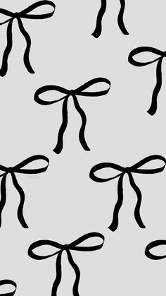 black and white bows are on a gray background with the word love written below them